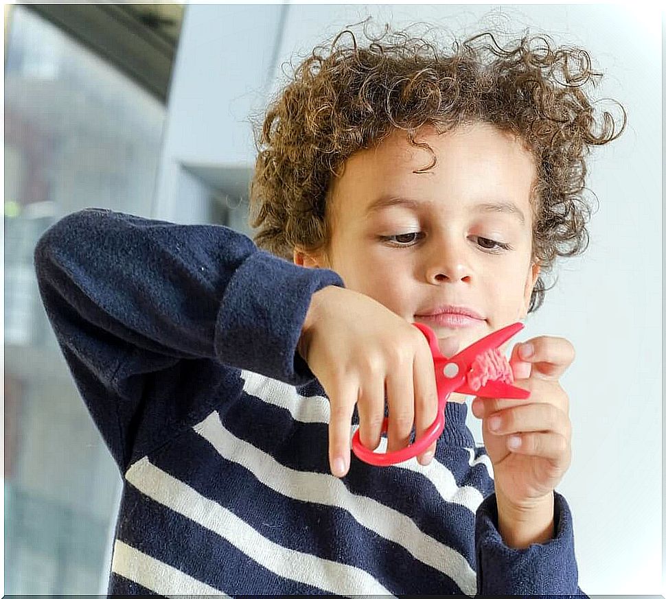 child using children's scissors