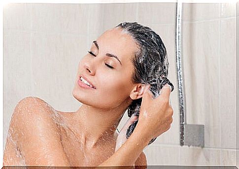 Woman washing her hair with homemade shampoos.