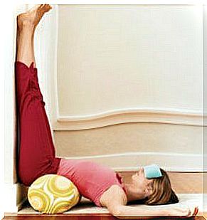 Woman stretching with legs up to eliminate stress