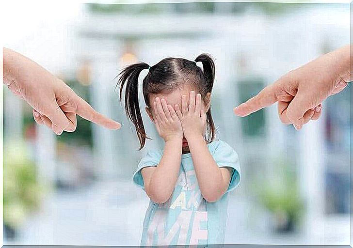 Parents pointing the finger at little daughter