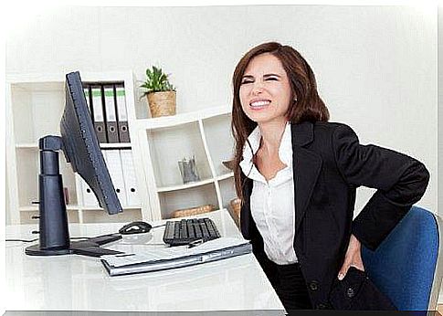 Woman with back pain at work.